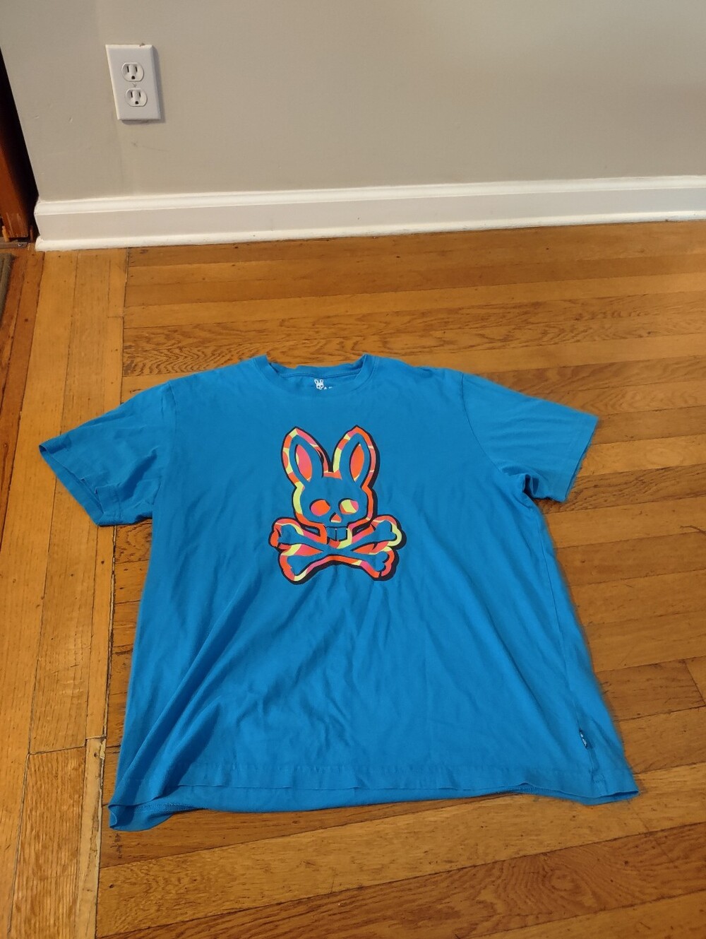 blue psycho bunny with orange and yellow logo shirt size 7 (XL)